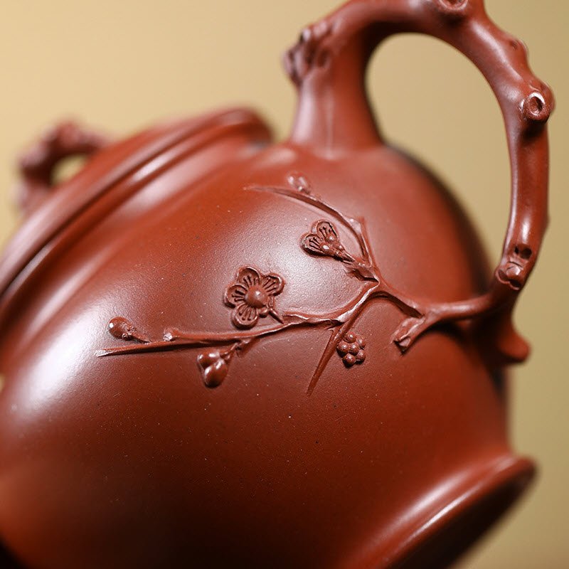 Ấm tử sa báo xuân quai ấm giống cành mai